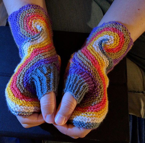 Handknitted gloves with a spiral around the thumbs